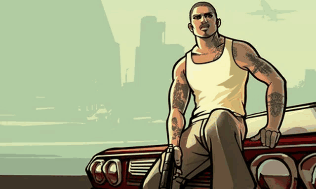 a man in a tank top is sitting on the side of a car holding a gun .