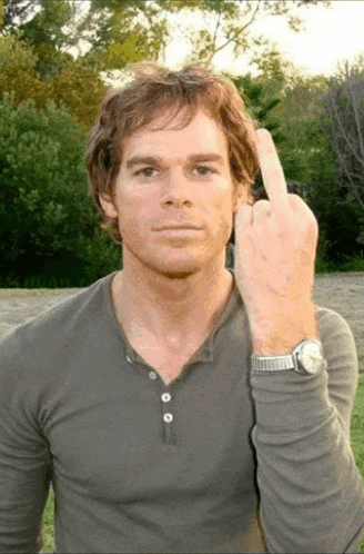 a man wearing a watch shows his middle finger