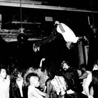 a man is flying through the air in a crowd