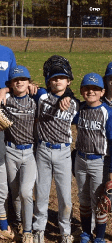 a group of young boys are posing for a picture with one wearing a titans jersey