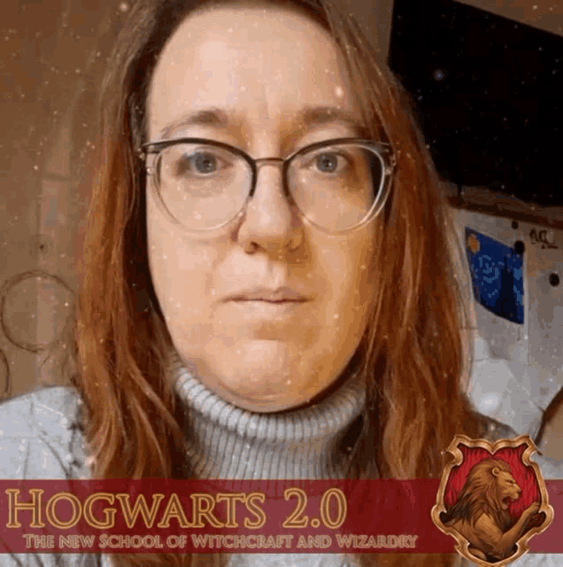 a woman wearing glasses stands in front of a hogwarts 2.0 advertisement