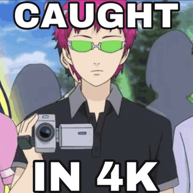 a man wearing green sunglasses is holding a video camera and says " caught in 4k "