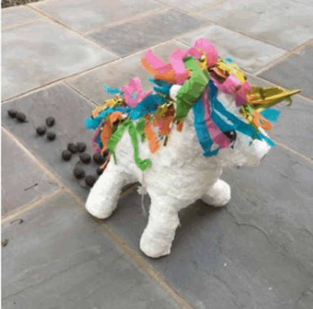 a stuffed unicorn with colorful ribbons on it 's mane