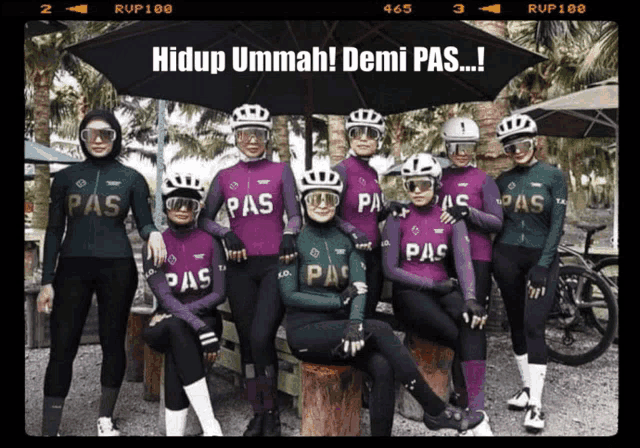 a group of women wearing purple and green pas jerseys pose for a photo