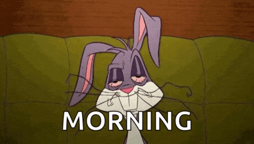 bugs bunny is laying on a couch with his eyes closed and the words morning written below him .