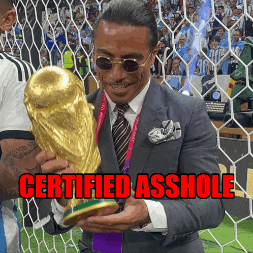 a man in a suit is holding a trophy with the words certified asshole below him