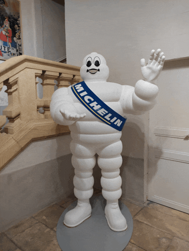 a statue of a man with a sash that says michelin on it