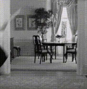 a black and white photo of a dining room with starz written on the bottom right