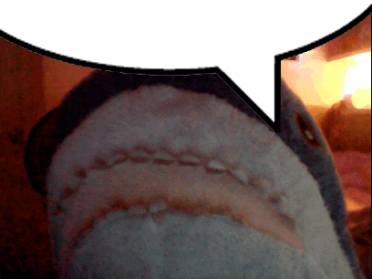 a close up of a shark 's mouth with a speech bubble behind it