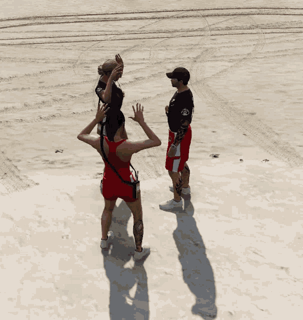 a group of people standing on a sandy beach one of whom has a tattoo on his arm that says ' a '