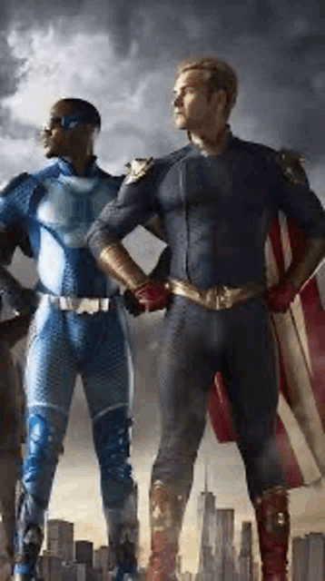 two superheros are standing next to each other in front of a city .