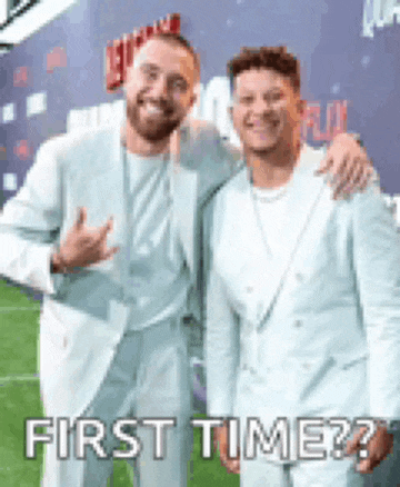 two men in suits are posing for a picture and the caption says first time