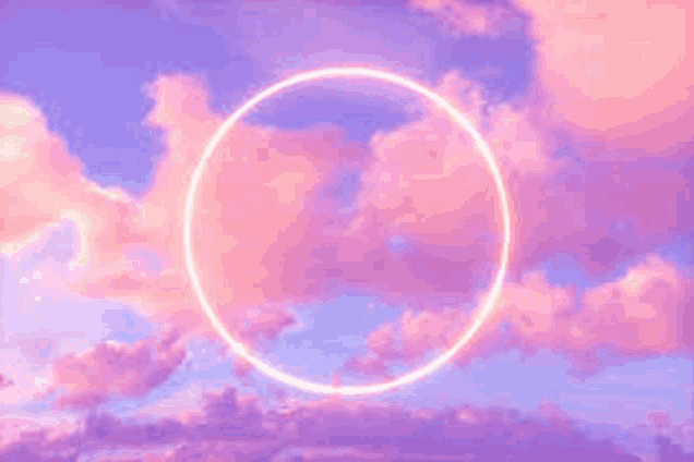 there is a neon circle in the sky with pink clouds .