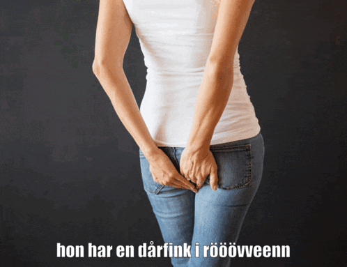 a woman holds her butt in front of a black background with hon har en darfink i roovveenn written below her