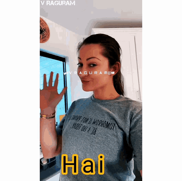 a woman wearing a gray shirt that says hai