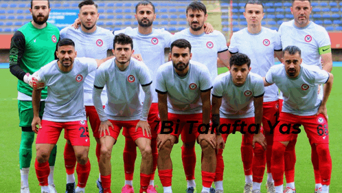 a group of soccer players are posing for a team photo with the words bi tolatfa yas written on the bottom