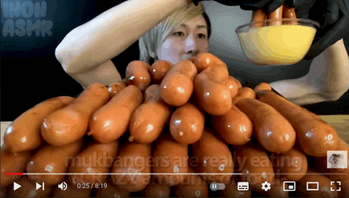 a video of a person eating a bunch of sausages with the words mukbangers are really eating at the bottom