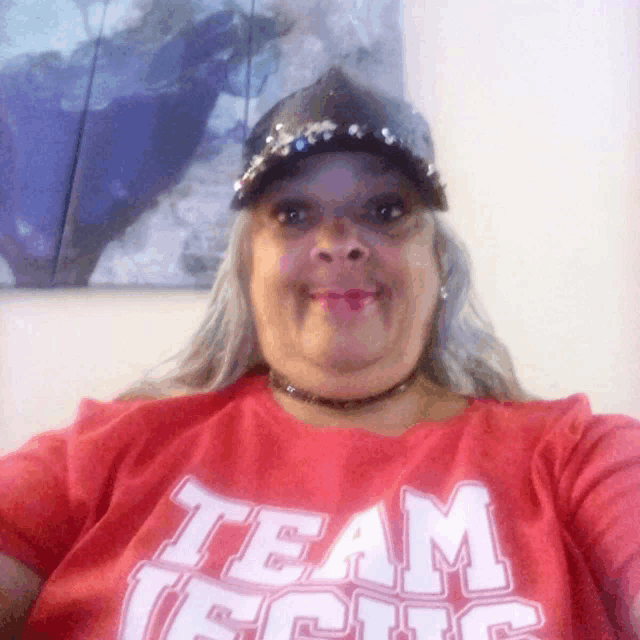 a woman wearing a red shirt that says team focus on it