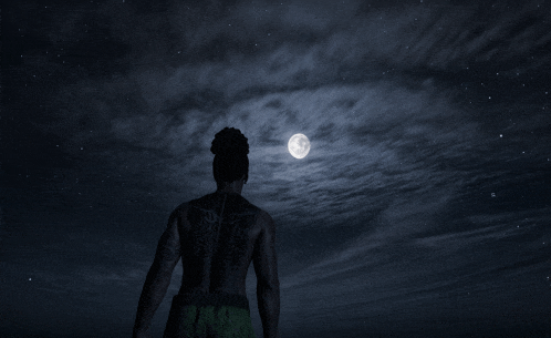 a man with dreadlocks stands in front of a full moon