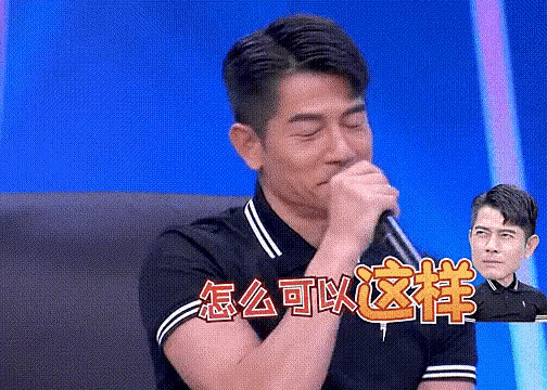 a man is holding a microphone in front of his mouth with chinese writing above him