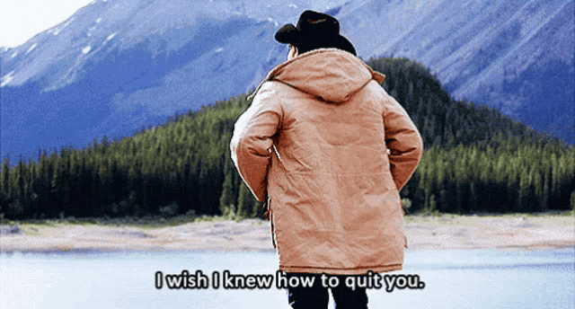 a man in a parka stands in front of a mountain and says " i wish i knew how to quit you