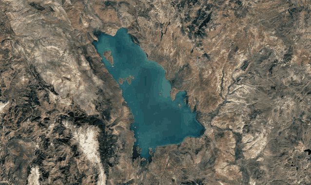 a large body of water surrounded by mountains and rocks