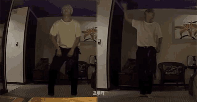 a man is dancing in a room with asian writing on the wall