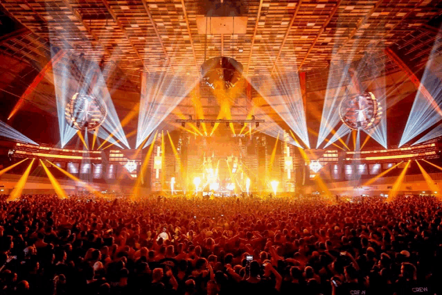 a crowd of people at a concert with the word crew on the back