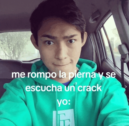 a man in a green hoodie is sitting in a car with a caption that says me rompo la pierna