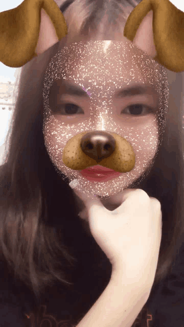 a girl with a dog mask on her face looks at the camera