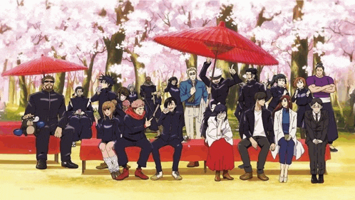 a group of people sitting under red umbrellas in front of cherry blossom trees