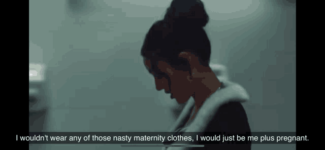 a woman with a bun on her head is talking about nasty maternity clothes