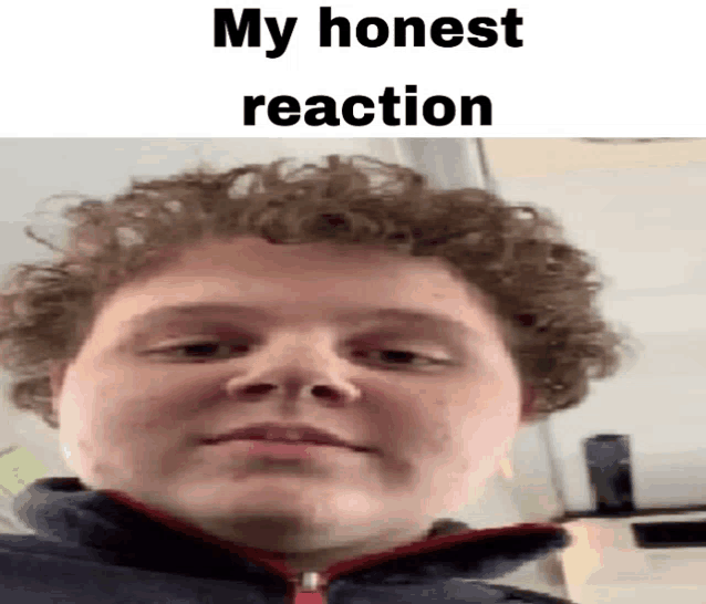 a young man with curly hair is making a funny face while wearing a blue jacket .