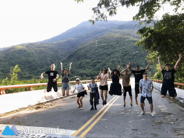 a group of people are jumping in the air in front of a mountain and the word momento is on the bottom