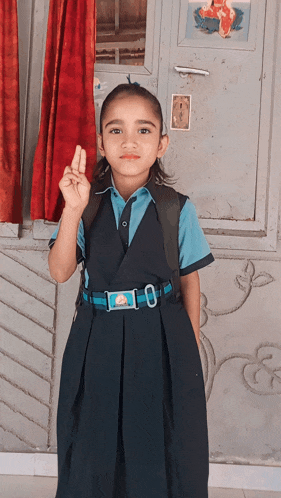 a little girl wearing a school uniform with the number 10 on it