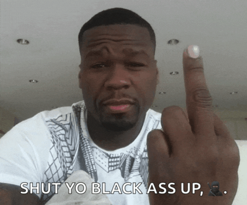 a man giving the middle finger with the words shut yo black ass up underneath him