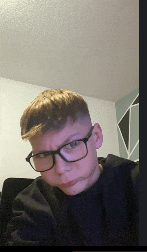 a young boy wearing glasses and a black sweater