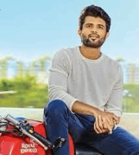 a man with a beard is sitting on a motorcycle .