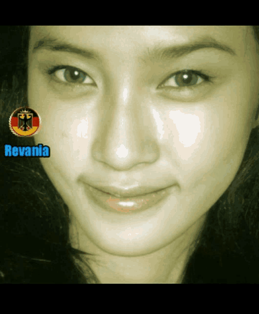 a close up of a woman 's face with the name revania on the bottom right