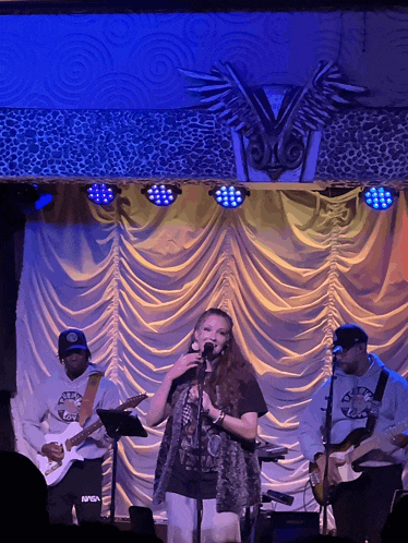 a man in a nasa sweatshirt stands next to a woman on stage