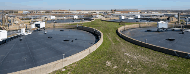 an aerial view of a water treatment facility with a large circular tank in the middle