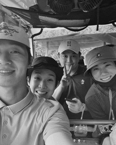 a group of people in a golf cart one wearing a hat that says tiger woods on it