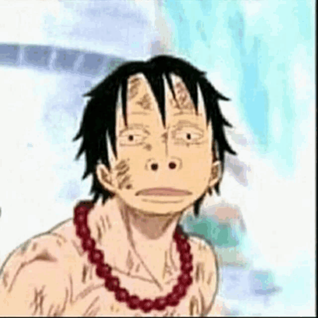 a monkey d luffy from one piece is wearing a red necklace .