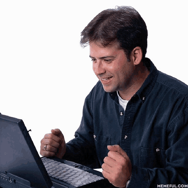 a man sitting in front of a laptop computer with memeful.com written on the bottom right