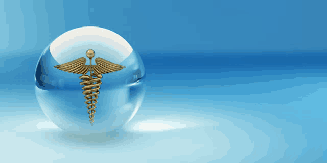 a glass ball with a caduceus symbol on it