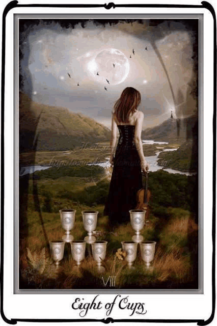 a tarot card shows a woman holding a violin and the eight of cups card