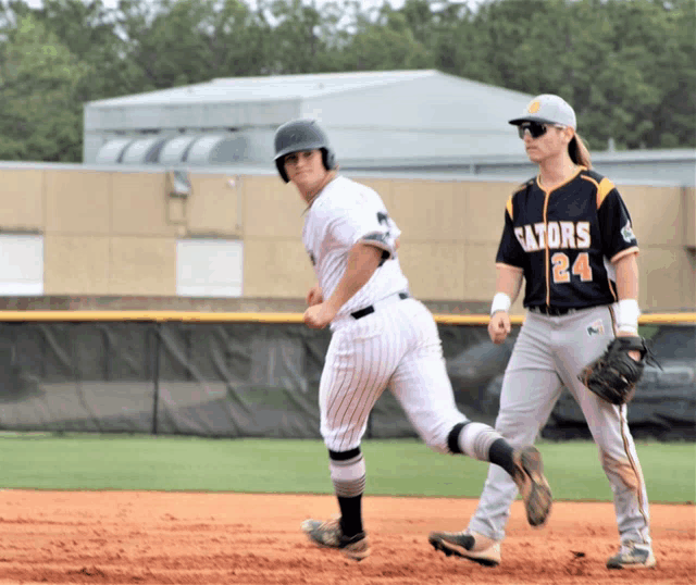 a baseball player with the number 24 on his jersey is running