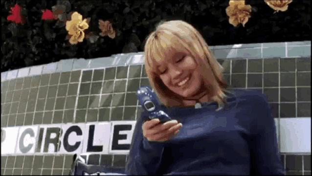 a woman is sitting in front of a sign that says circle .