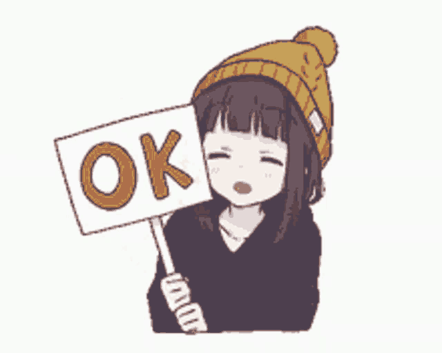 a girl holding a sign that says ok on it