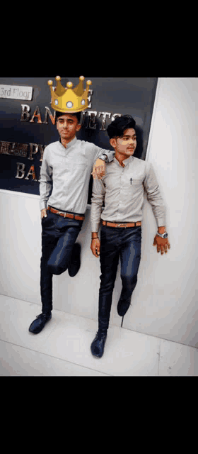 two young men standing in front of a sign that says 3rd floor banquet